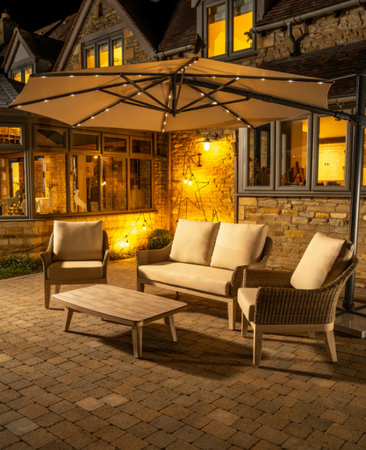 Orion 3m Round LED Cantilever Parasol with Granite Base & Night Cover at Night